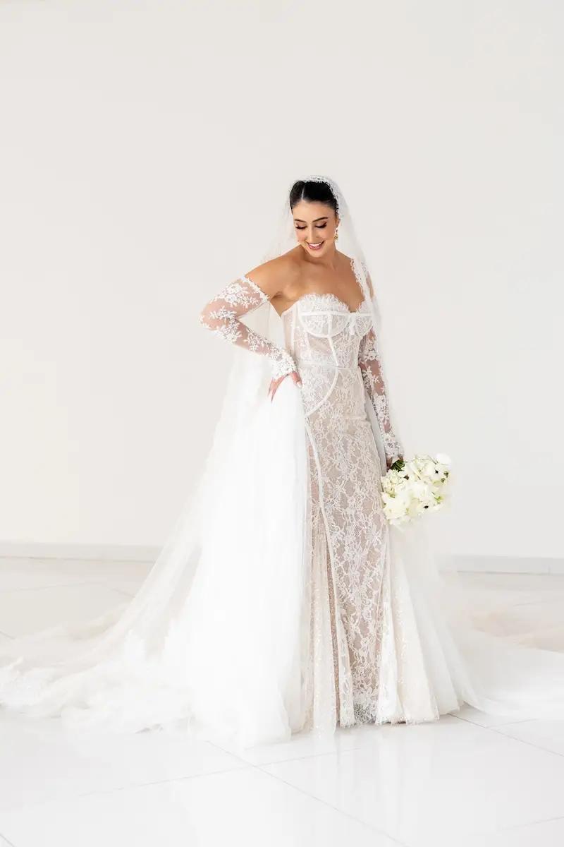Andrea Wears Illusion Lace Wedding Dress with Removable Sleeves. Mobile Image