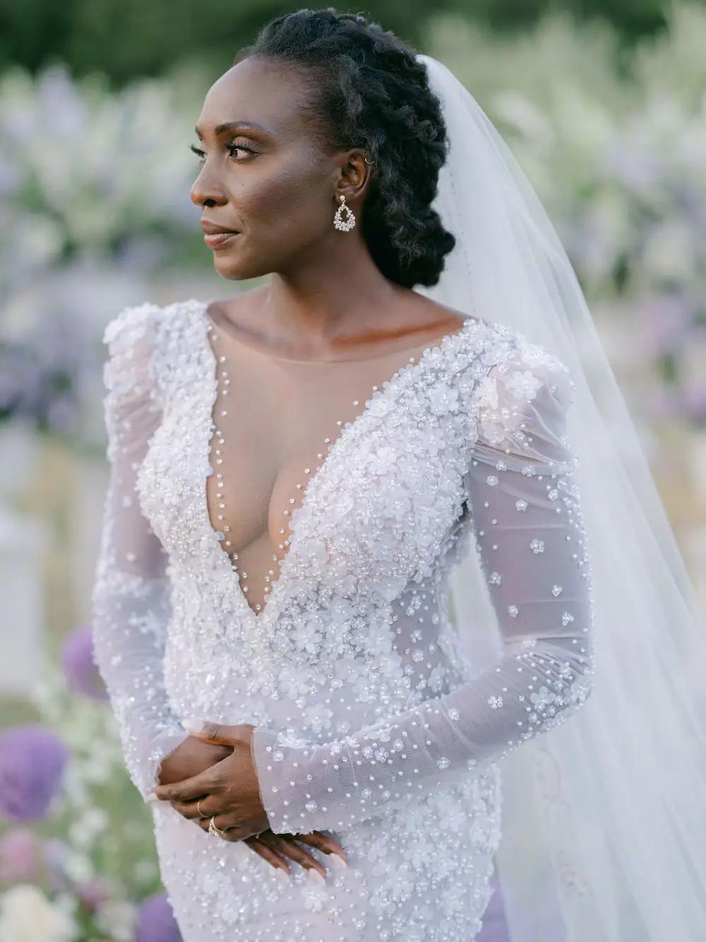Agatha Wears Long Sleeve, Illusion Lace Wedding Dress with Pearls For Destination Wedding. Mobile Image