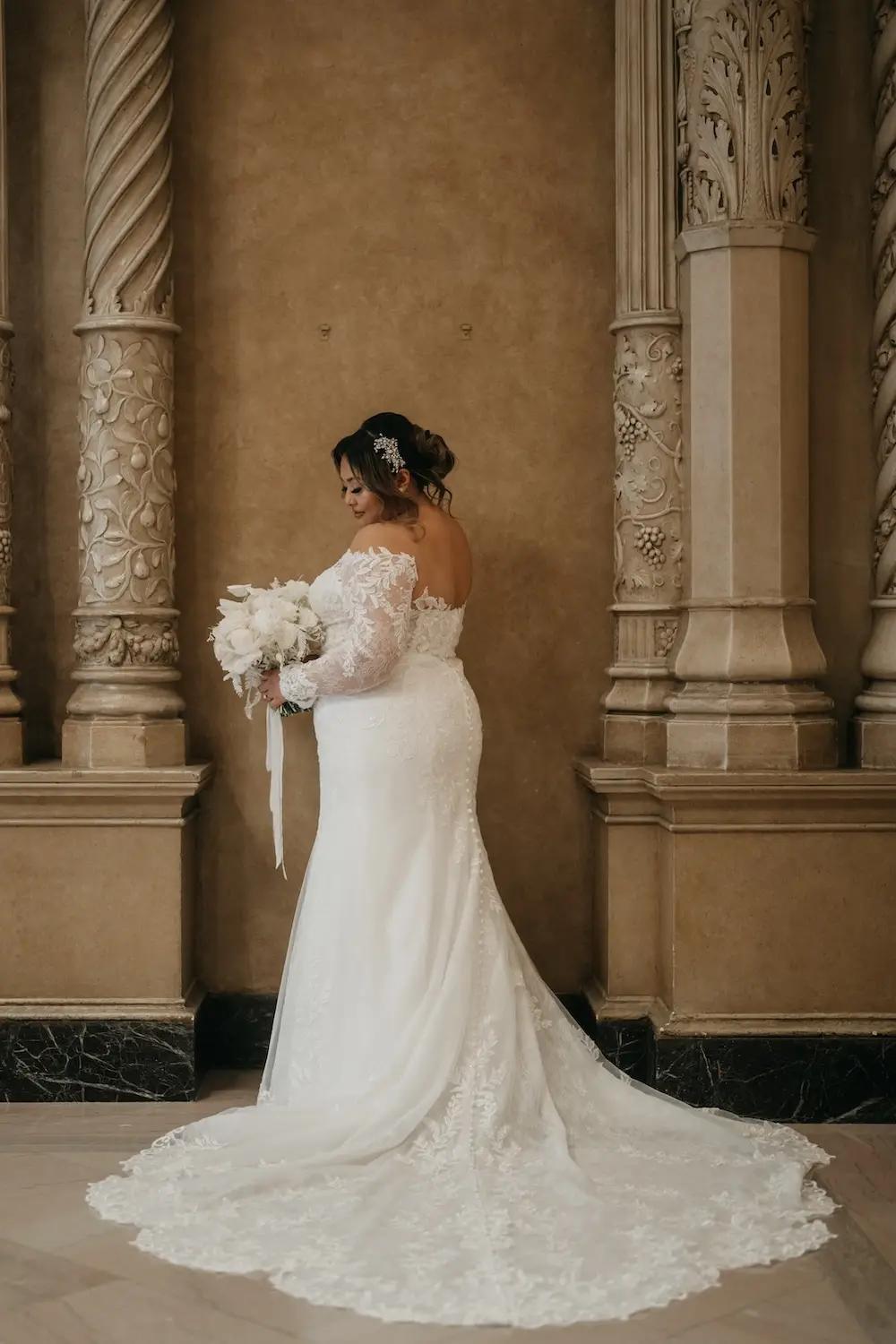 Aivanna Wears Off The Shoulders Lace Wedding Dress with Long Sleeves. Mobile Image